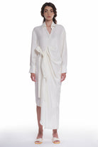 ASYMMETRICAL LONG SHIRT-DRESS WITH RUFFLE ON THE SIDE, OPEN COLLAR, TIED WITH A BELT, BUTTONING ON THE BACK