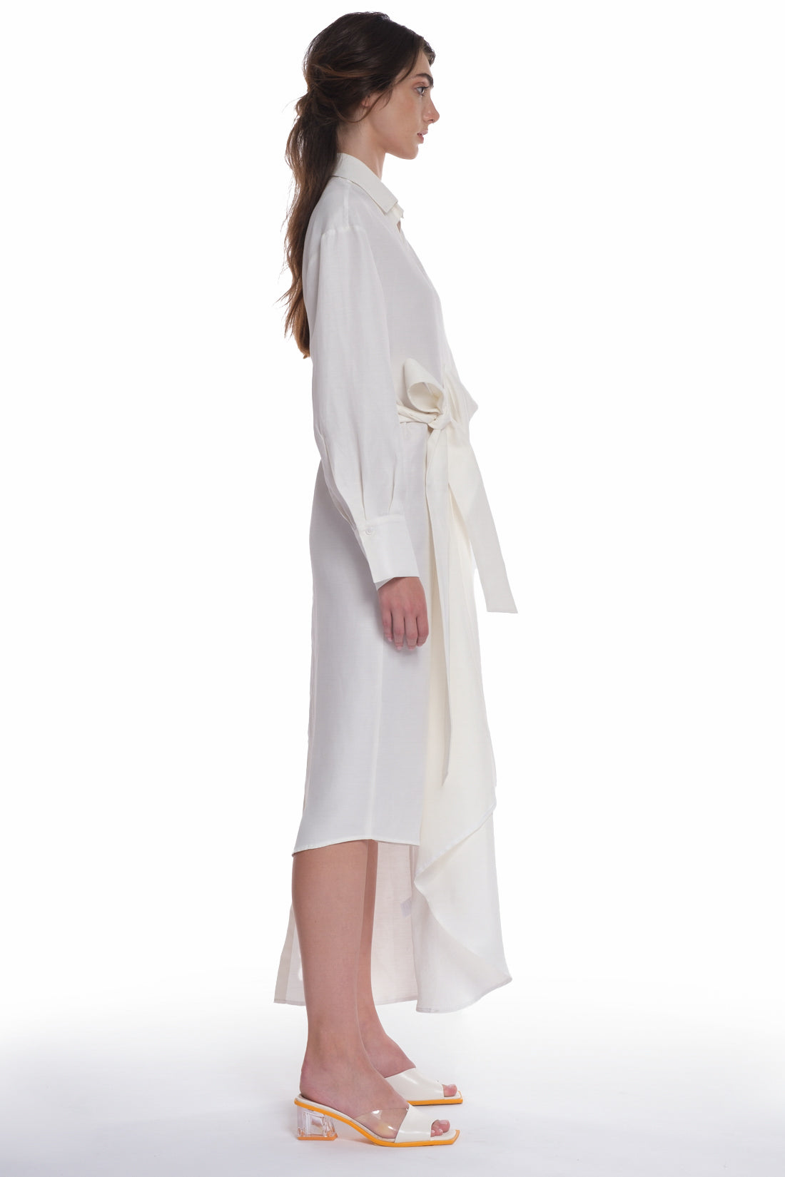 ASYMMETRICAL LONG SHIRT-DRESS WITH RUFFLE ON THE SIDE, OPEN COLLAR, TIED WITH A BELT, BUTTONING ON THE BACK