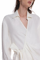 ASYMMETRICAL LONG SHIRT-DRESS WITH RUFFLE ON THE SIDE, OPEN COLLAR, TIED WITH A BELT, BUTTONING ON THE BACK