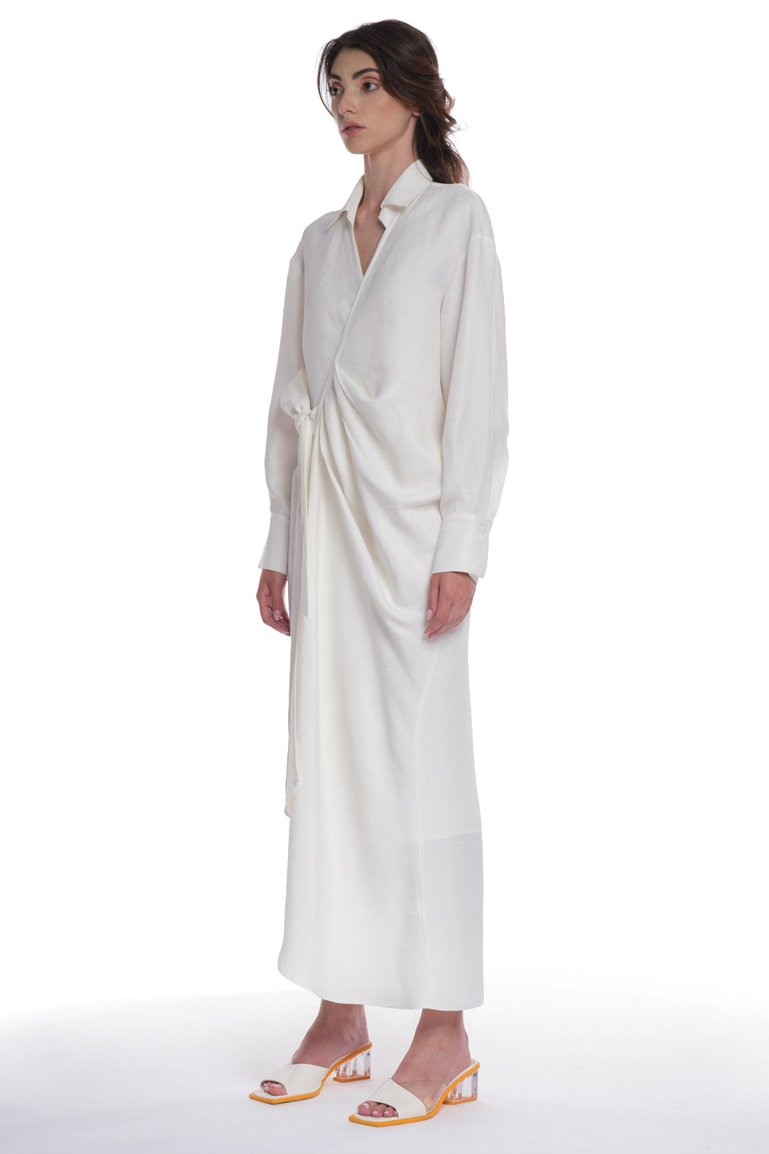 ASYMMETRICAL LONG SHIRT-DRESS WITH RUFFLE ON THE SIDE, OPEN COLLAR, TIED WITH A BELT, BUTTONING ON THE BACK