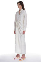 ASYMMETRICAL LONG SHIRT-DRESS WITH RUFFLE ON THE SIDE, OPEN COLLAR, TIED WITH A BELT, BUTTONING ON THE BACK