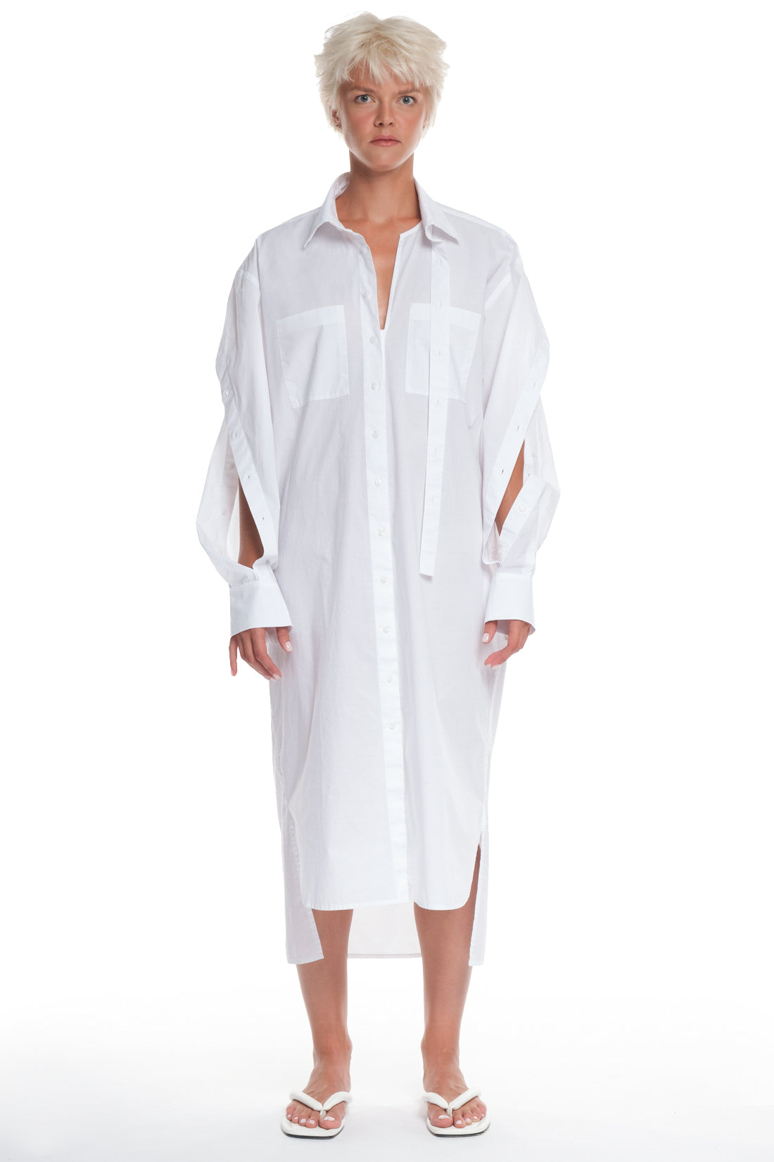 LONG SHIRT-DRESS WITH CUTTINGS AND BUTTONING ON THE SLEEVES, INTERESTING CUTTING ON THE COLLAR, LONGER ON THE BACK, POCKETS IN FRONT