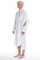 LONG SHIRT-DRESS WITH CUTTINGS AND BUTTONING ON THE SLEEVES, INTERESTING CUTTING ON THE COLLAR, LONGER ON THE BACK, POCKETS IN FRONT