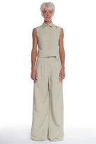 LONG HIGH-WAISTED PANTS WITH CUTTINGS AND POCKETS ON THE BACK.