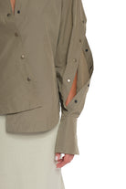 RAIN PROOF SHIRT WITH OPEN SLEEVES, CUTTING AND BUTTONING ON EACH OF THEM, OPEN COLLAR, OVERLAPPING IN FRONT