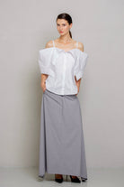 a white off-the-shoulder blouse with dramatic puffed sleeves 
